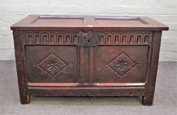 A 17th century oak coffer, with double panel lid and carved double panel front, on stile feet, 99cm wide x 58cm high.