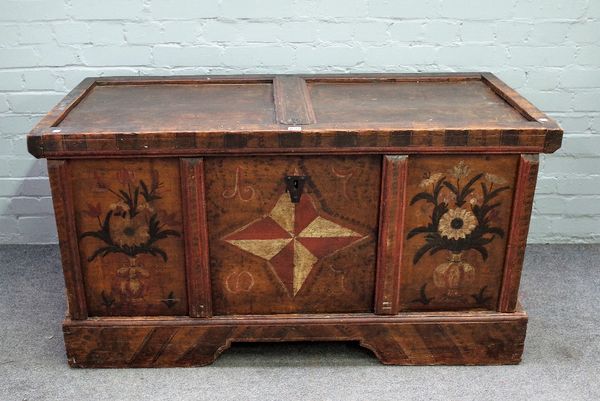 A 19th century North European polychrome painted pine trunk, with twin panel lid over triple panel front,resting on a stand, 132cm wide x 70cm high.