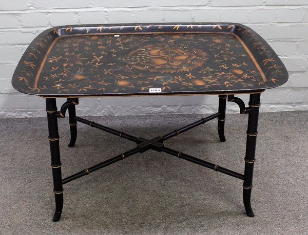 A 19th century tole peinte rectangular tray, on later faux bamboo stand, 81cm wide x 48cm high.