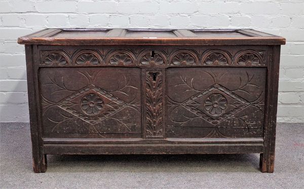 A 17th century oak coffer with triple panel lid over carved double panel front on stile feet, 110cm wide x 60cm high.