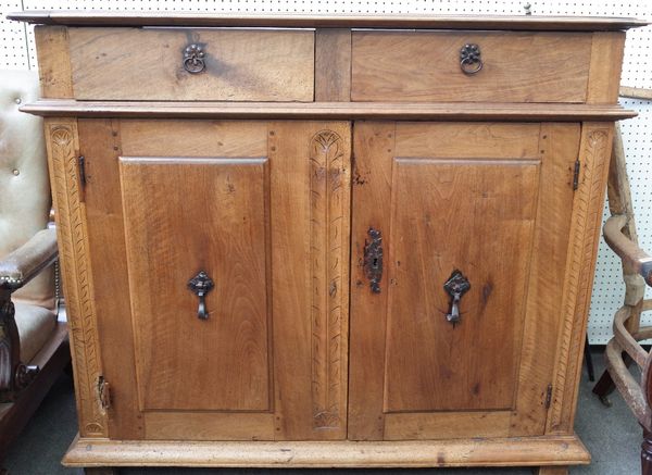 A 17th century and later Italian walnut commode with a pair of drawers over pair of cupboards, 138cm wide x 123cm high.