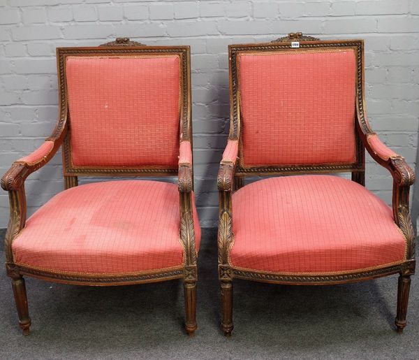 A pair of Louis XVI single square back open arm fauteuils, on tapering fluted supports, 71cm wide x 103cm high.