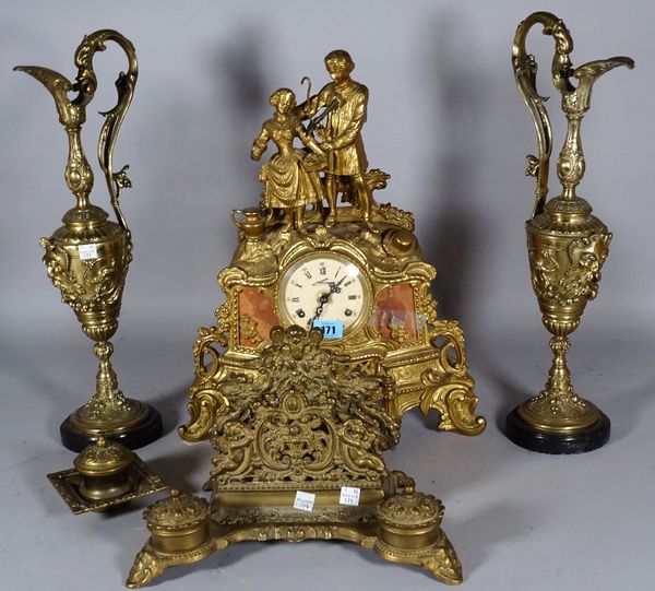 A 20th century Continental gilt metal mantel clock with eight day movement, the scroll moulded case surmounted with a courting couple on scroll feet,