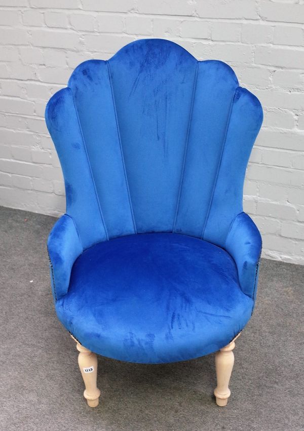 A Victorian style button back armchair, with studded blue upholstery, on turned supports, 65cm wide x 103cm high.