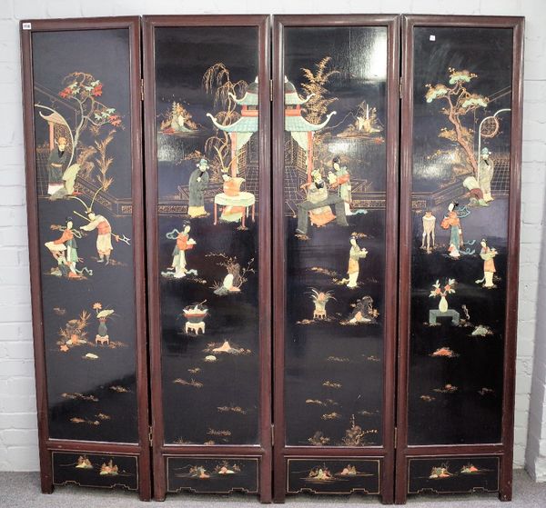 An early 20th century Chinese hardwood framed black lacquer four fold draught screen, relief inset with soap stoned figures, 184cm wide x 183cm high.