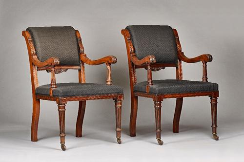 A pair of 19th century mahogany framed open armchairs, with acanthus capped arms and straight front seats, on ebonised fluted supports, 60c, wide x 95
