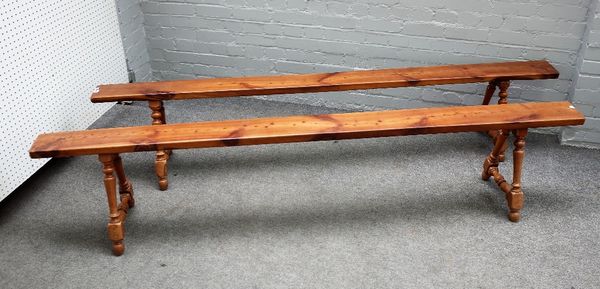 A pair of 19th century French fruitwood benches on turned supports, 227cm wide x 45cm high.