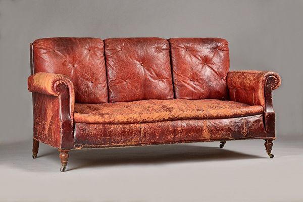 An early 20th century French rouge leather upholstered three seater sofa, on turned mahogany supports, 198cm wide x 97cm high. Illustrated.