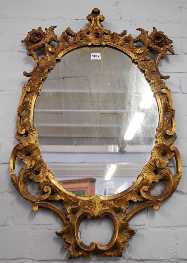 A George III oval wall mirror with pierced swept acanthus and 'C' scroll frame, 50cm wide x 78cm high.