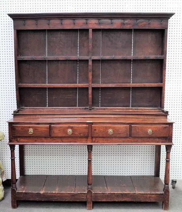 An 18th century oak dresser, the enclosed two tier plate rack over three frieze drawers on turned supports united by potboard undertier, 160cm wide x