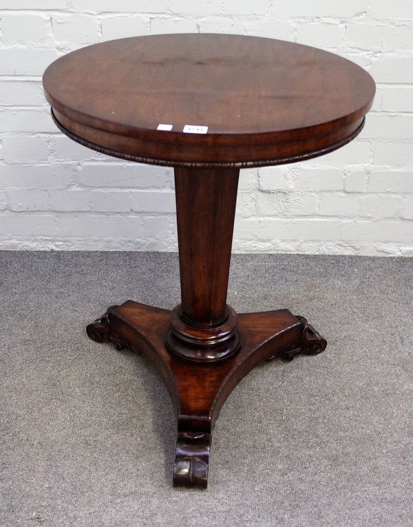 A Regency style hardwood circular occasional table, on tapering octagonal column and three scroll feet, 56cm diameter x 69cm high.