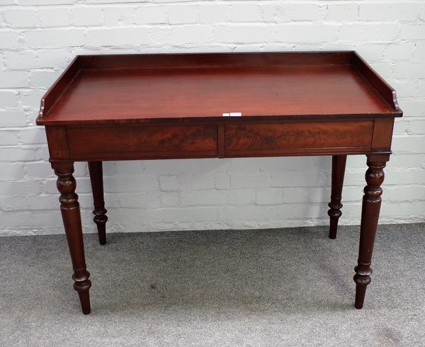 An early 19th century mahogany two drawer writing desk on turned supports, 108cm wide x 80cm high.