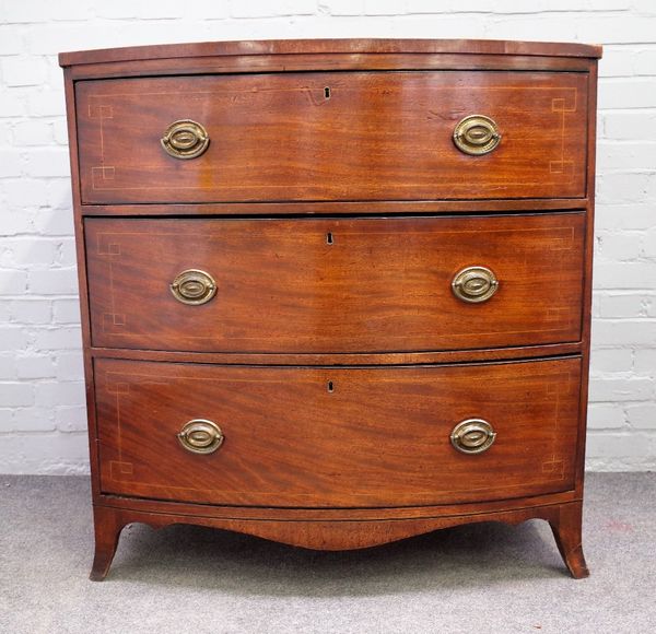 A Regency inlaid mahogany bowfront chest with three long graduated drawers, on splayed bracket feet, 100cm wide x 104cm high.