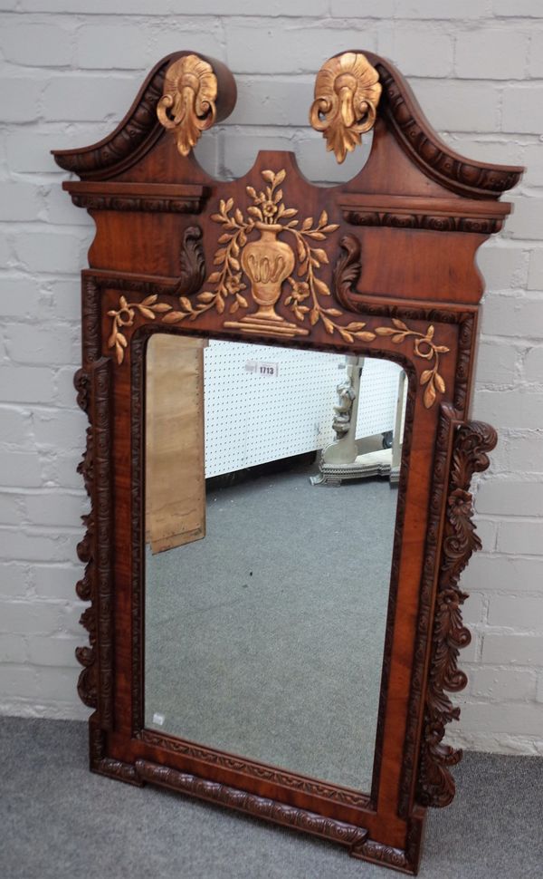 A George II style parcel gilt mahogany mirror with swan neck pediment, 70cm wide x 126cm high.