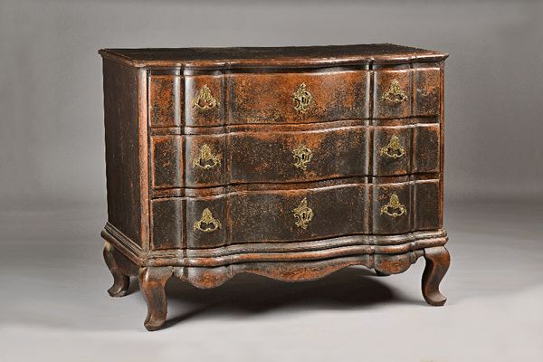 An 18th century North Italian ebonised serpentine three drawer commode, on squat pointed cabriole supports, 126cm wide x 98cm high. Illustrated.