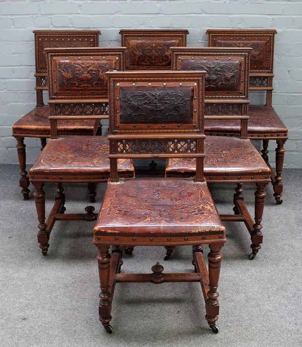 A set of twelve 19th century French walnut dining chairs, with embossed leather square backs, on turned supports, 47cm wide x 91cm high, (12).