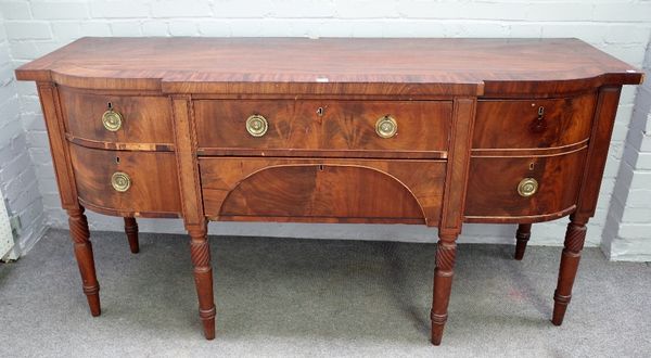 A George III inlaid mahogany sideboard, with five frieze drawers on spiral turned supports, 184cm wide x 97cm high.