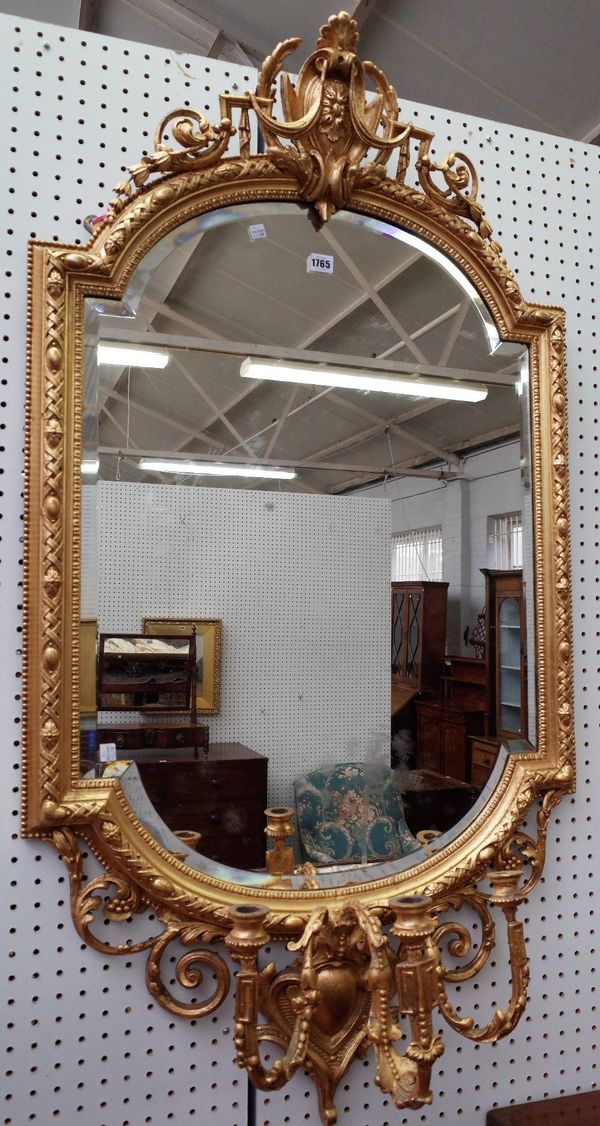 A 19th century gilt framed girandole wall mirror, with cartouche crest over shaped plate and triple branch candlestick, 70cm wide x 135cm high.