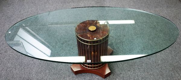 A 20th century coffee table, the oval glass top on reeded column, 168cm wide x 50cm high.