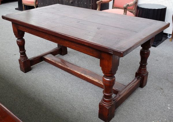 A 17th century style oak refectory table, the cleated plank top on turned supports, 91cm wide x 166cm long.