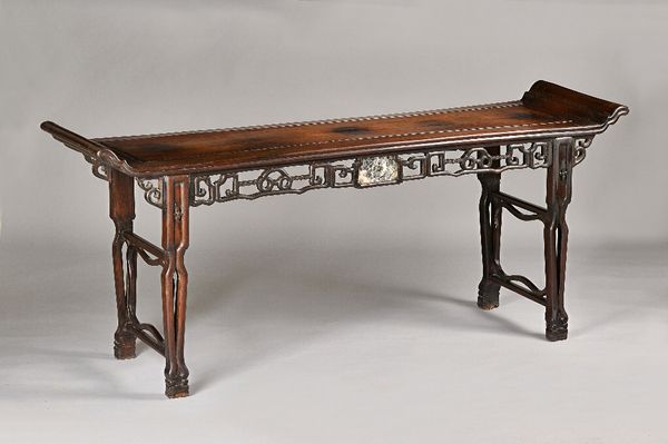 A late 19th century Chinese hardwood altar table, the rectangular top with upswept ends, over marble inset pierced frieze, on shaped supports, 200cm w