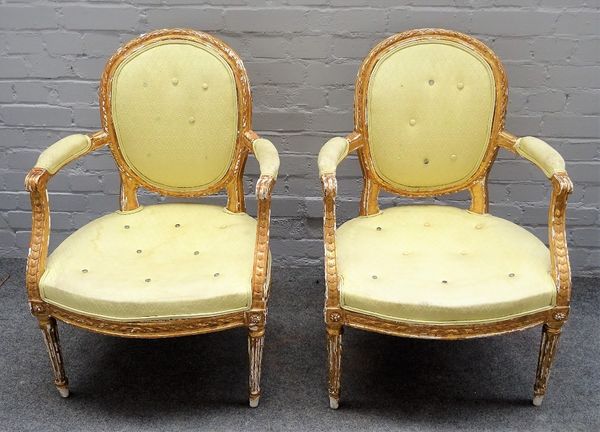 A pair of George III gilt framed open armchairs, with semi padded arms and bow seat on tapering fluted supports, 60cm wide x 88cm high, (2).