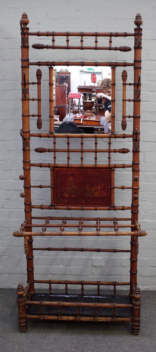 A Victorian bamboo hall stand, with central mirror in a hook surround over stick stand, 82cm wide x 210cm high.