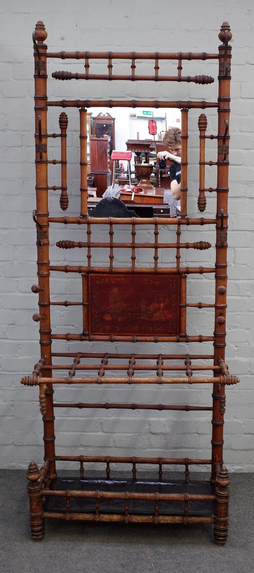 A Victorian bamboo hall stand, with central mirror in a hook surround over stick stand, 82cm wide x 210cm high.