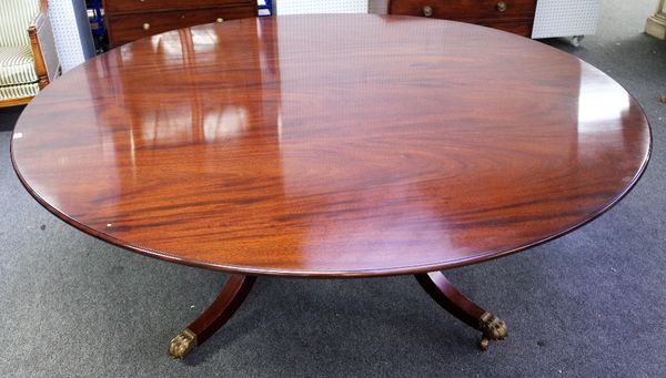 Williams Tillman; a George III style circular mahogany dining table on four downswept supports, united by concave platform undertier, 197cm diameter x