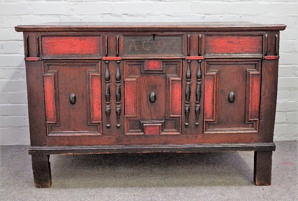 A 17th century oak coffer, the plank top over geometric moulded triple panel front, on stile feet, 116cm wide x 79cm high.