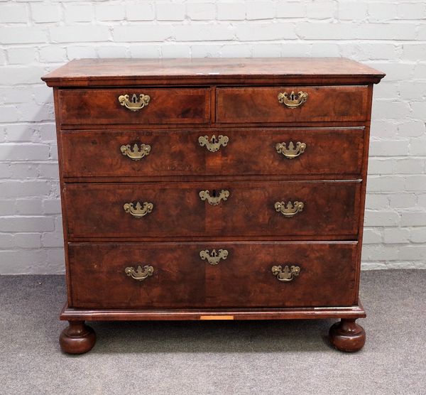 A mid-18th century figured walnut chest of two short and three long graduated drawers, on bun feet, 102cm wide x 93cm high.