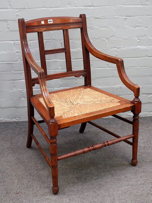 A late 19th century Arts and Crafts beech and walnut square back open armchair, on turned supports, 58cm wide x 89cm high.