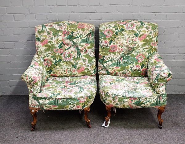 A pair of Victorian asymmetrical easy armchairs, on gilded scroll supports, each 70cm wide x 90cm high, (2).