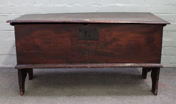 A 17th century elm plank coffer, on slab end supports, 105cm wide x 55cm high.