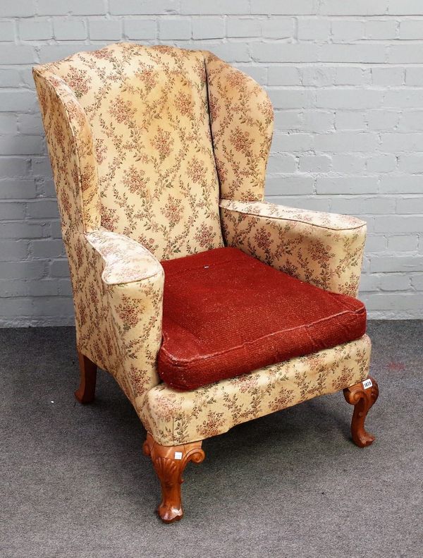 A George II style wingback armchair, on shell capped cabriole supports, 83cm wide x 109cm high.