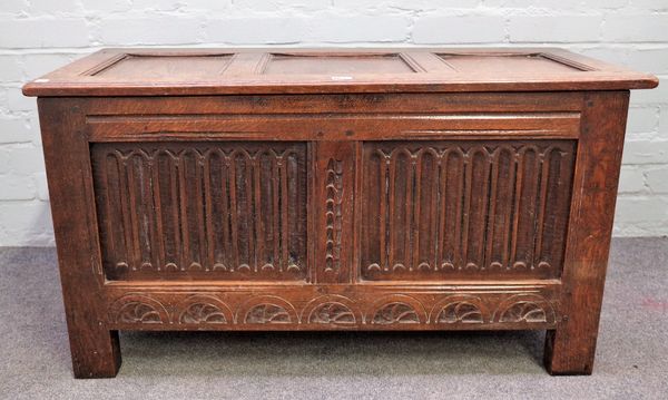 An 18th century oak coffer, with triple panel lid and carved double panel front, on stile feet, 97cm wide x 52cm high.