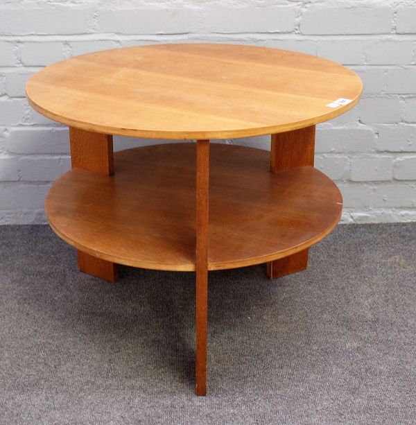 A 20th century circular laminated oak and beech two tier circular table, 64cm diameter x 51cm high.