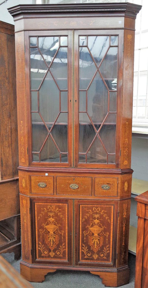 An Edwardian marquetry inlaid satin wood banded floor standing corner display cabinet cupboard with pair of astragal glazed doors over single drawer a