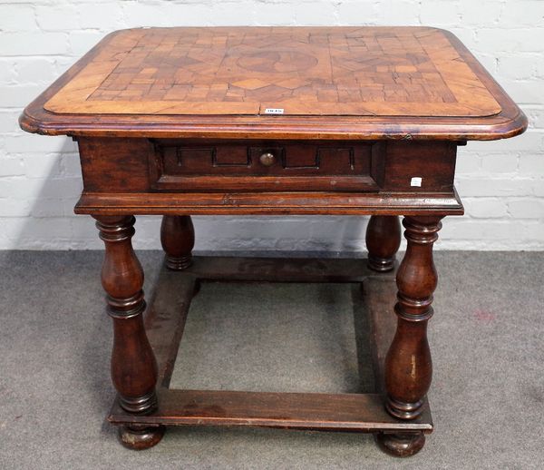 A 19th century North European centre table, the primitive square parquetry inlaid top, over single frieze drawer, on baluster supports, united by peri