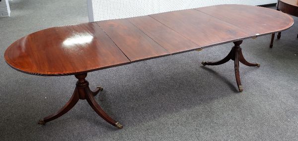 A Regency style mahogany 'D' end extending dining table on pair of tripod bases with three extra leaves, 108cm wide x 168cm long x 288cm long fully ex