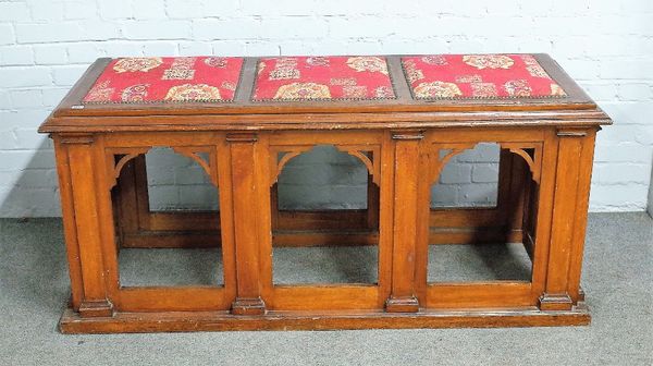 A 19th century Gothic Revival oak bench, with padded seat, over pierced arch base, 155cm wide x 66cm.