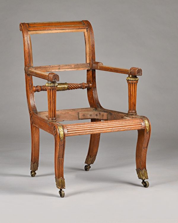 In the manner of George Bullock; a Regency brass mounted oak open armchair with rope twist waist rail and sabre supports, 57cm wide x 92cm high. Illus