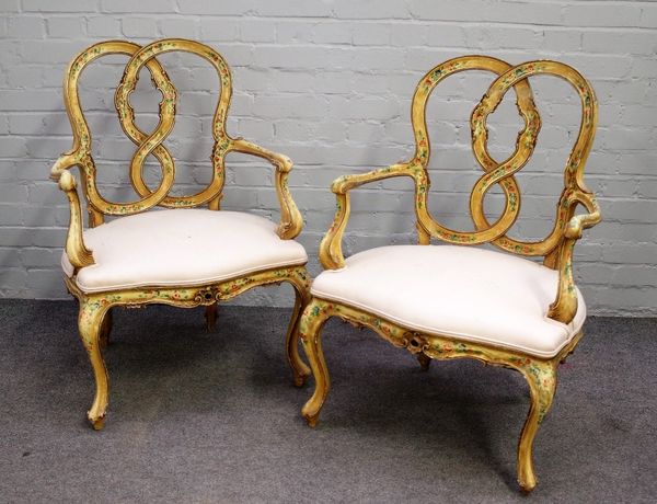 A pair of 18th century style polychrome painted open armchairs, with interlocked back and serpentine seat, on cabriole supports, 62cm wide x 92cm high