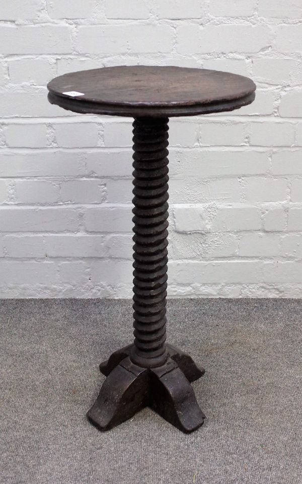 An 18th century oak candle table, the circular top on spiral fluted column, 37cm diameter x 68cm high.