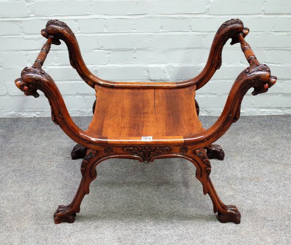 A 19th century Italian walnut 'X' frame stool, with beast head finial's and paw feet, 75cm wide x 60cm high.