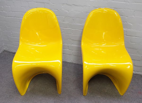 Probably Verner Panton; a pair of yellow resin moulded chairs, 47cm wide x 87cm high, (2).