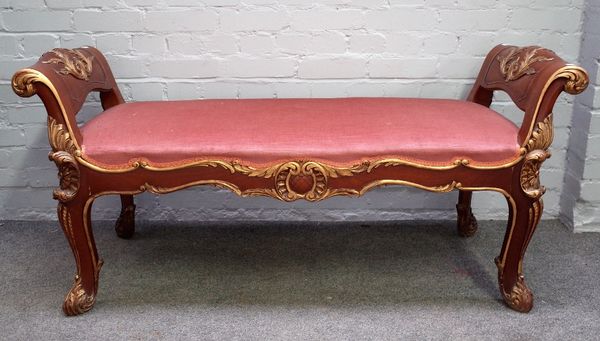 A Rococo Revival parcel gilt mahogany window seat with scroll ends and supports, 135m wide x 66cm high.