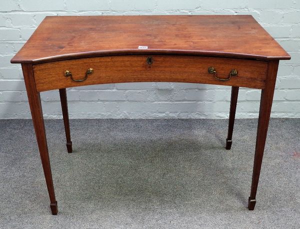 An early 19th century mahogany concave side table, with single frieze drawer on tapering square supports, 92cm wide x 73cm high.