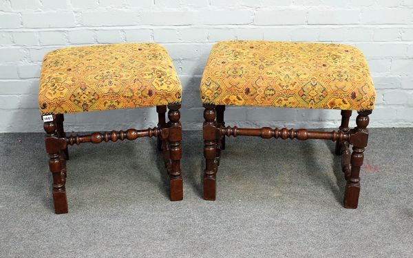 A pair of 17th century style rectangular stools with over-stuffed tops, on block and turned supports, 60cm wide x 51cm high.