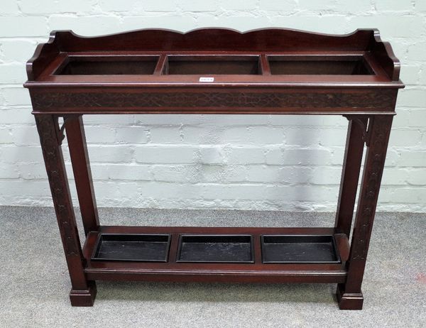 Gill & Reigate London W; a late 19th century mahogany three division stick stand, with blind fret decoration, 87cm wide x 77cm high.